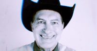 Close-up black and white of Joe Bob wearing a cowboy hat.