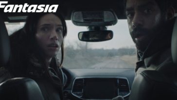 Rose and Teddy sit in a car and turn their bodies toward the back seat in Next Exit