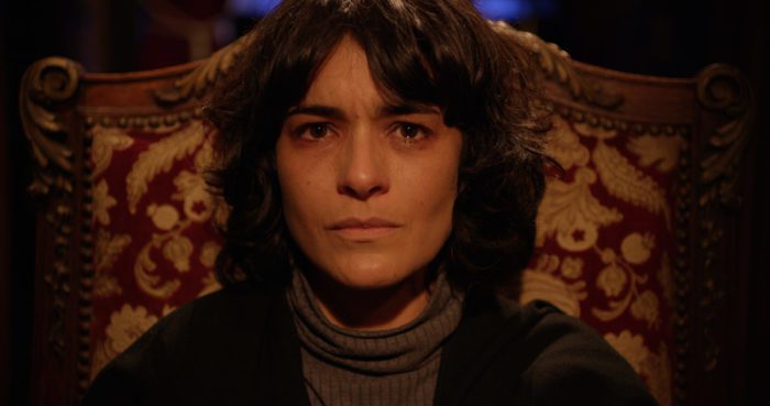 A woman sits in a chair staring into the camera in On the 3rd Day
