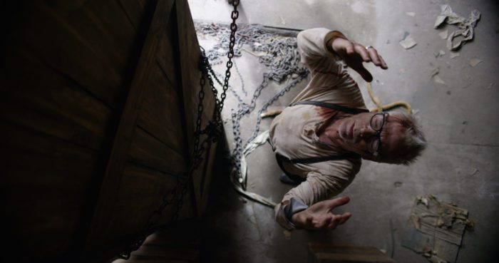 A grey haired man prays toward the ceiling in On the 3rd Day