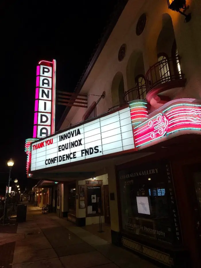 Outside the Panida Theater at night with the marquee lit up.