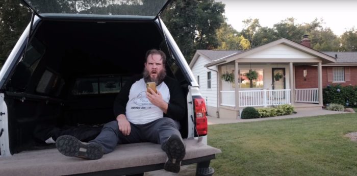 Matt sits on the tailgate of his truck in front of a house in All Your Friends Are Dead