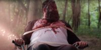 Matt sits tied to a chair covered in blood out in the woods in All Your Friends Are Dead