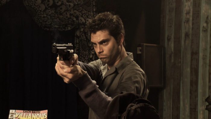 A man holding a gun with a frustrated look on his face