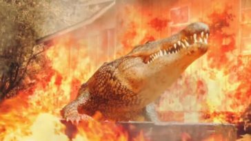 A gigantic alligator stomping through a cloud of flames
