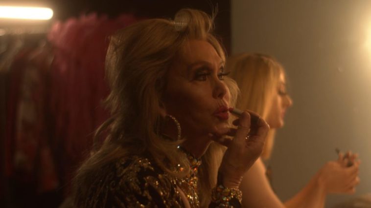 A drag queen dons her makeup before stage