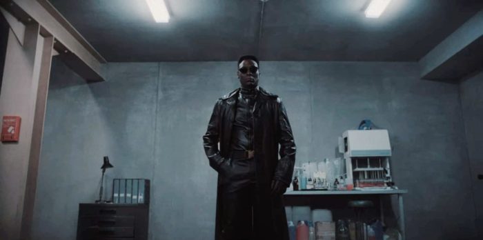 Albert Wesker stands in black leather and sunglasses