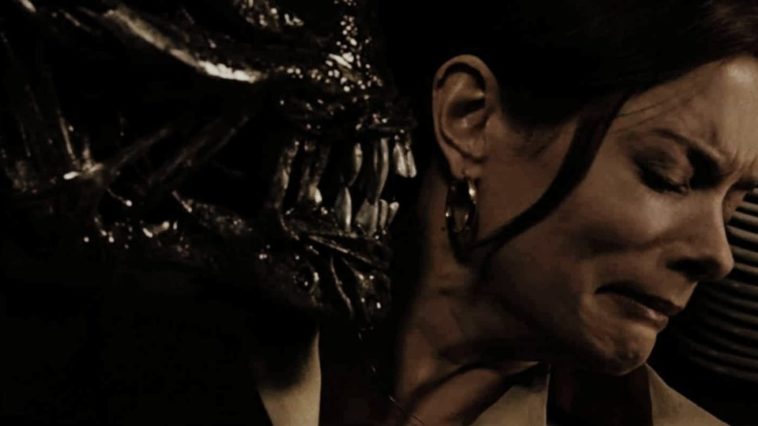 A Xenomorph puts its mouth in the personal space of a resistant woman in Aliens Vs. Predator Requiem