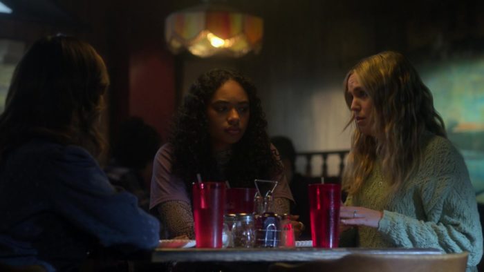 The girls sit at their table in the pizza place, after being cleared of wrongdoing for Karen's death