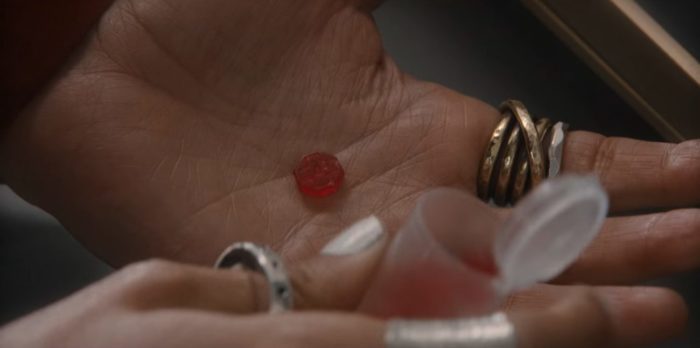 A hand holds a dose of the Resident Evil series drug, Joy