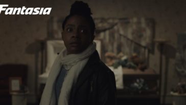 Monique looks toward the camera in The Harbinger