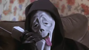 David Sheridan's Ghost Face character from Scary Movie (2000) goofs around on the phone with his tongue hanging out.