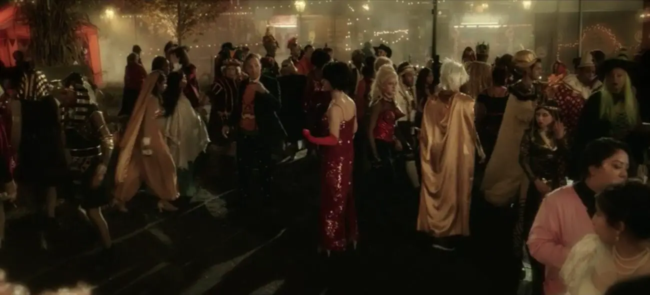 A crowd of Salem townspeople disperse from Mayor Jefrey Traske (Tony Hale), including some dressed as The Supremes and one woman dressed as Cone Bra Madonna, in the film, "Hocus Pocus 2" (2022).