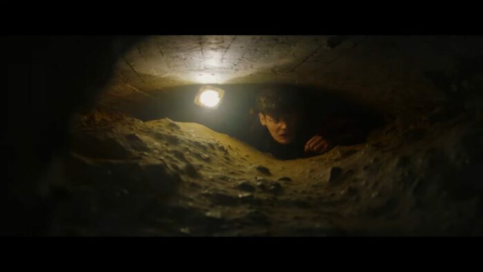 Max crawls through a cramped tunnel, which looks like there is not enough room for him to get through