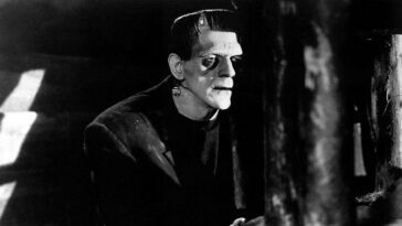 Karloff as The Monster, looms out of the shadow, his horrific face half lit while the other half stays in the gloom