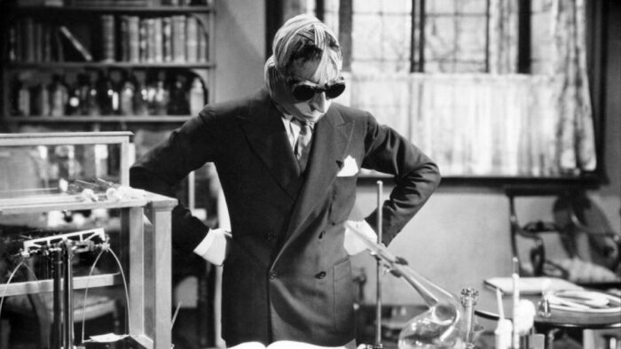 Claude Rains stands over a table, pondering how to change himself back into a human being, before he decends into madness and becomes a true monster