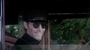 the image of a creepy smiling man wearing dark glasses