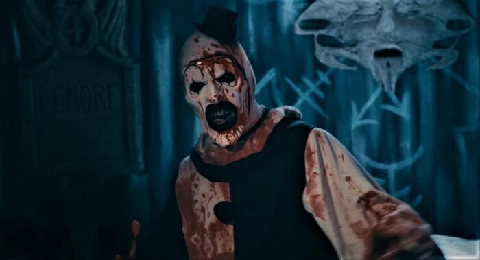 Art the Clown in his black and white makeup and matching outfit covered in blood.