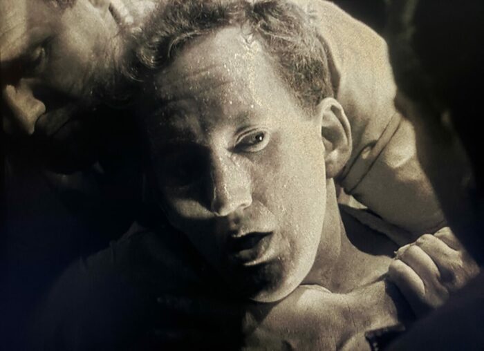 Black and white close-up on the terrified face of a mental patient in the horror film Curse of the Demon