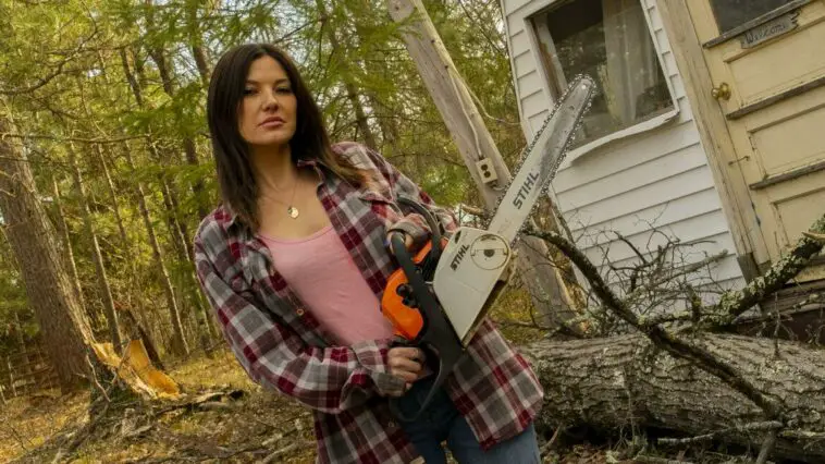 Marjorie (Eva Hamilton) stands holding a chainsaw in the movie Sawed Off