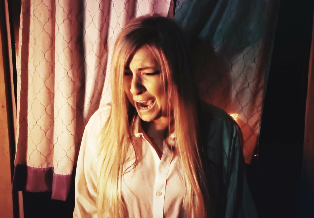 Natalie Peri screaming in terror in the shlock horror movie Amityville Thanksgiving