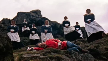 A bunch of women standing around another woman who's lying on the ground