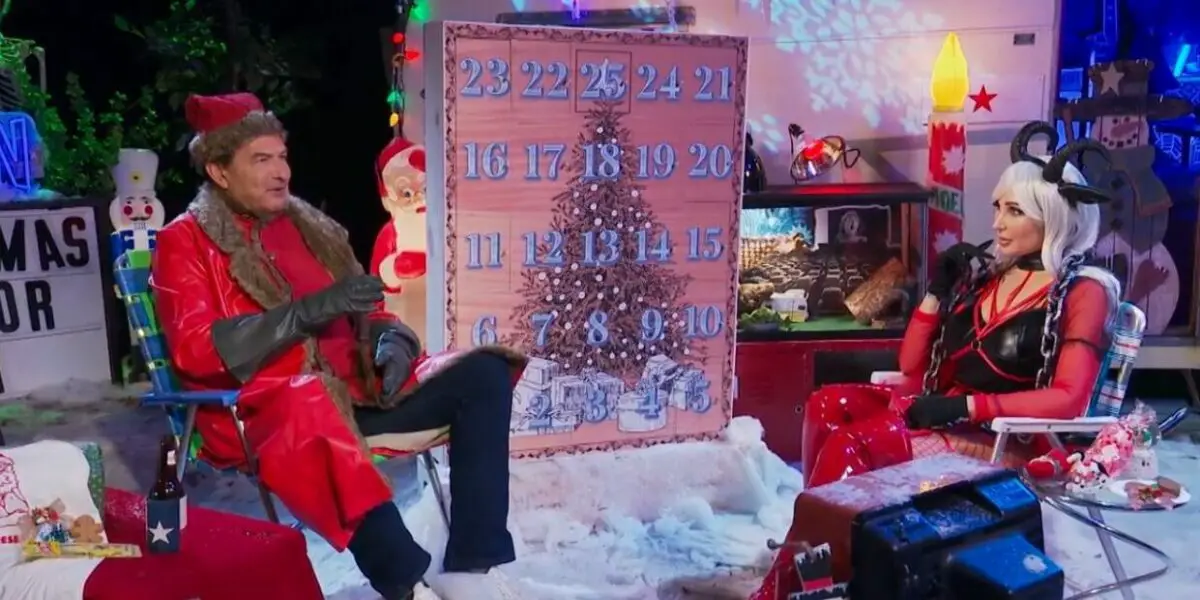 Joe Bob and Darcy, dressed in holiday themes, sit in front of a large advent calendar.