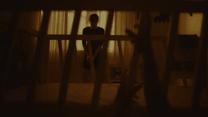 Valeria as seen through the bars of a crib