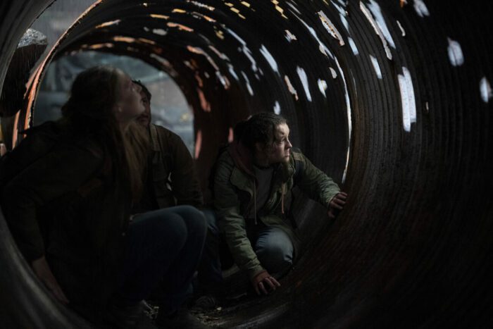 Tess, Joel, and Ellie hide in a rotted out metal tube in The Last of Us episode 1 “When You’re Lost in the Darkness.”