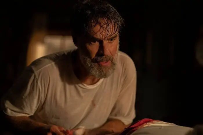 Frank stares intently, his t-shirt is soaked through and his hair is sopping wet in The Last of Us S1E3 "Long Long Time"