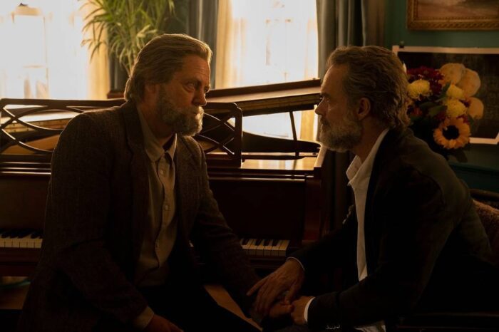 Bill and Frank hold hands and gaze into each other's eyes while sitting at a piano in The Last of Us episode 3 "Long Long Time"
