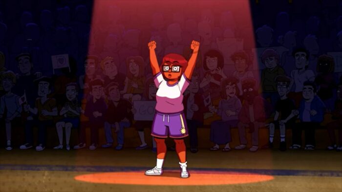 Velma holds her arms up in victory after defeating one opponent in her self defense tournament. 