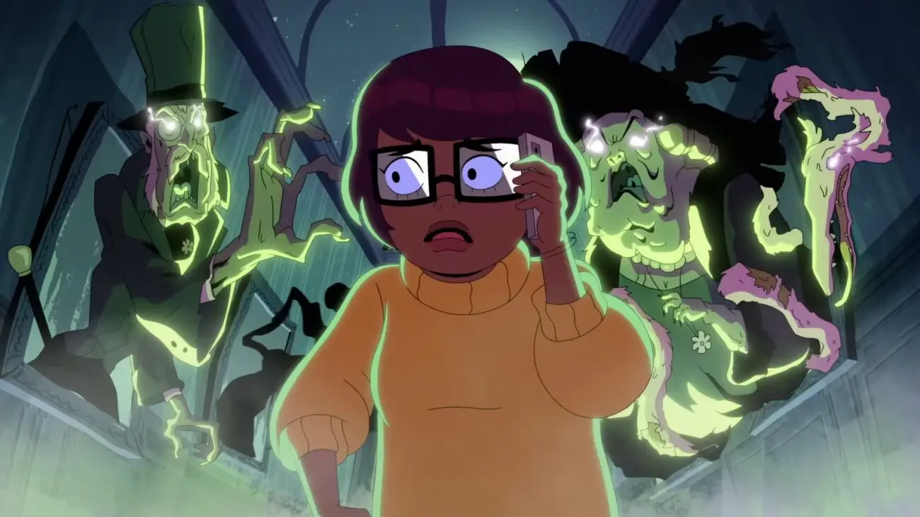 Velma is in Fred's house, multiple ghosts from her hallucinations come out of portraits
