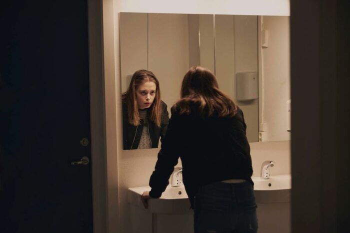 A girl looking at herself in a mirror