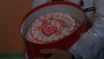 a circular cake in a round box that says Be My ♥