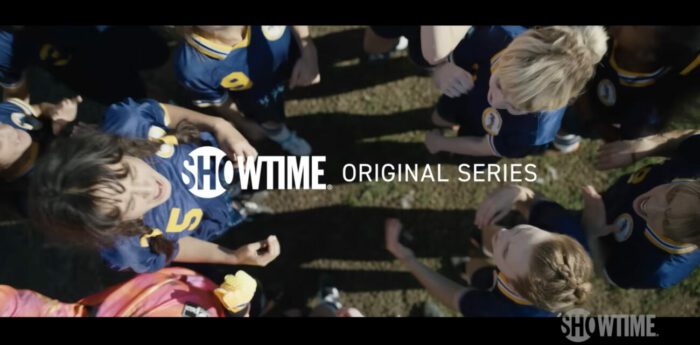 A girls’ soccer team in a huddle with the card “Showtime original series” displayed in an overlay