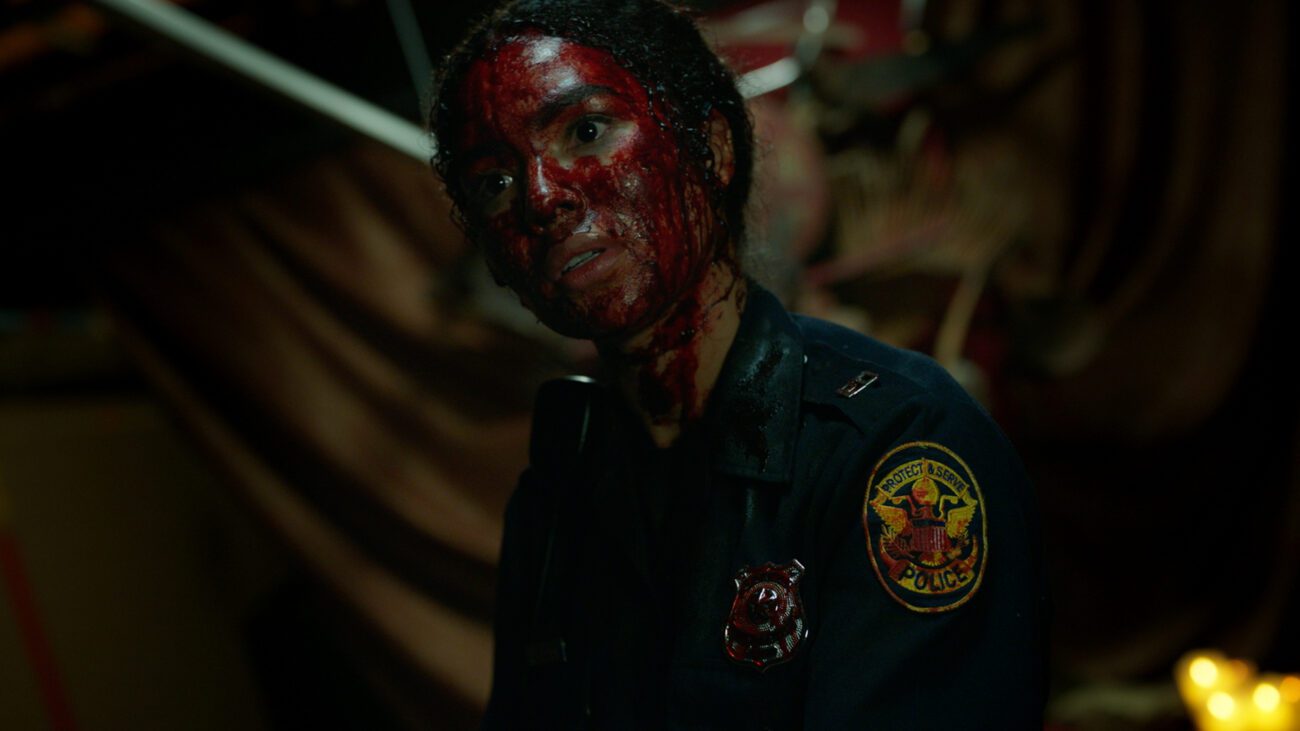 Jessica's face is covered in blood, as she stands there with her head titled