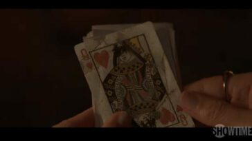 A queen of hearts card with the eyes scratched out