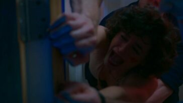 Mary hangs onto a doorway being pulled off of it by Brad and her hands being un clenched by Tony