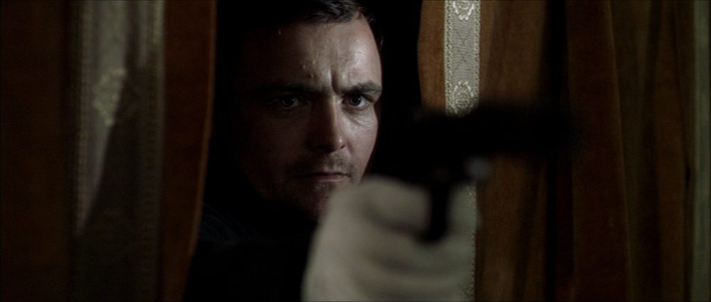 Jay, Neil Maskell, takes aim with a silenced pistol.