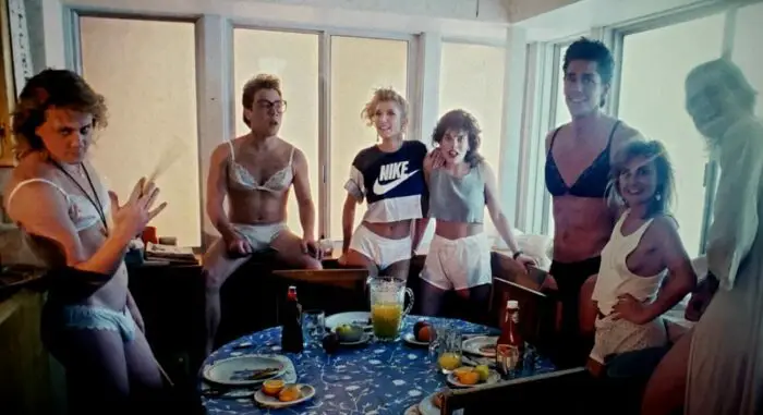 Left to right: Bryan Kovacs, Tom Shell, Annie Mikan, Lisa Elaina, Greg Joujon-Roche, Nikki McQueen, and Robert D. Peverley in Hard Rock Nightmare (1988). Screen capture off Shudder.