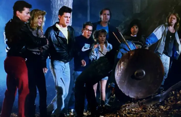 Left to right: Martin Hansen, Annie Mikan, Greg Joujon-Roche, Tom Shell, Nikki McQueen, Robert D. Peverley, Lisa Elaina, and Bryan Kovacs in Hard Rock Nightmare (1988). Screen capture off Shudder.