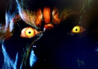 Close-up of glowing yellow werewolf eyes. Thomas Piccarillo as Dirk and the werewolf in Hard Rock Nightmare (1988). Screen capture off of Shudder.