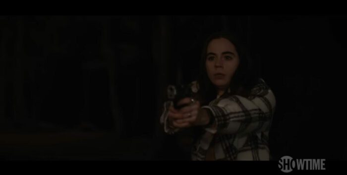 Callie holds a gun