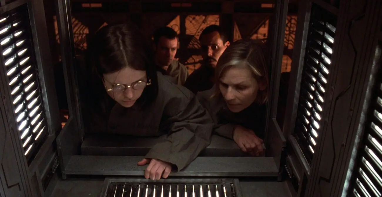 Leaven looks at numbers at the entrance to a room with the rest of the group in Cube