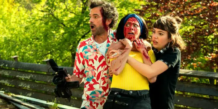 A bloodied woman is constrained by a man in a floral shirt and a woman in Final Cut