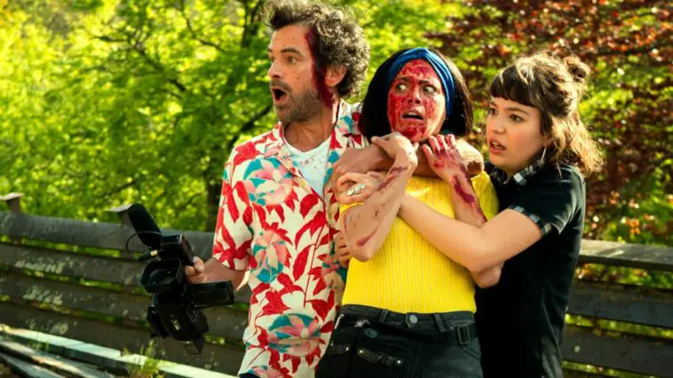 A bloodied woman is constrained by a man in a floral shirt and a woman in Final Cut