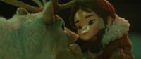 A person looking at a reindeer