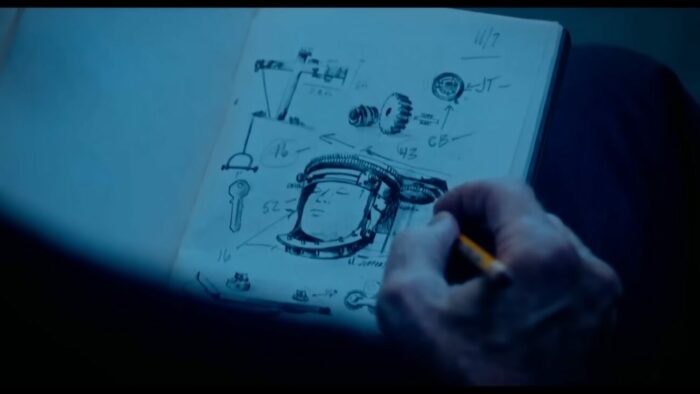 John Kramer sketches The Rack from Saw III in a notebook
