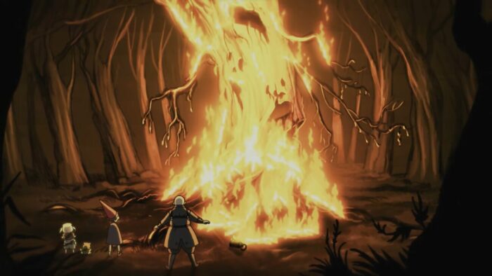 Wirt, Gregory, and The Woodsman stand in front of a burning Edelwood tree